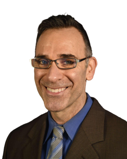 A smiling man in glasses wearing a brown suit and tie.